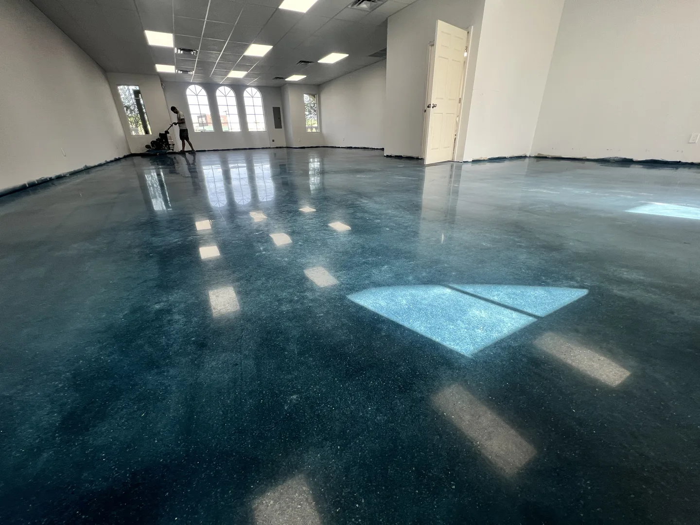 Commercial polished concrete floor with mirror-like reflections by Floor Kings Epoxy in Port St. Lucie, FL